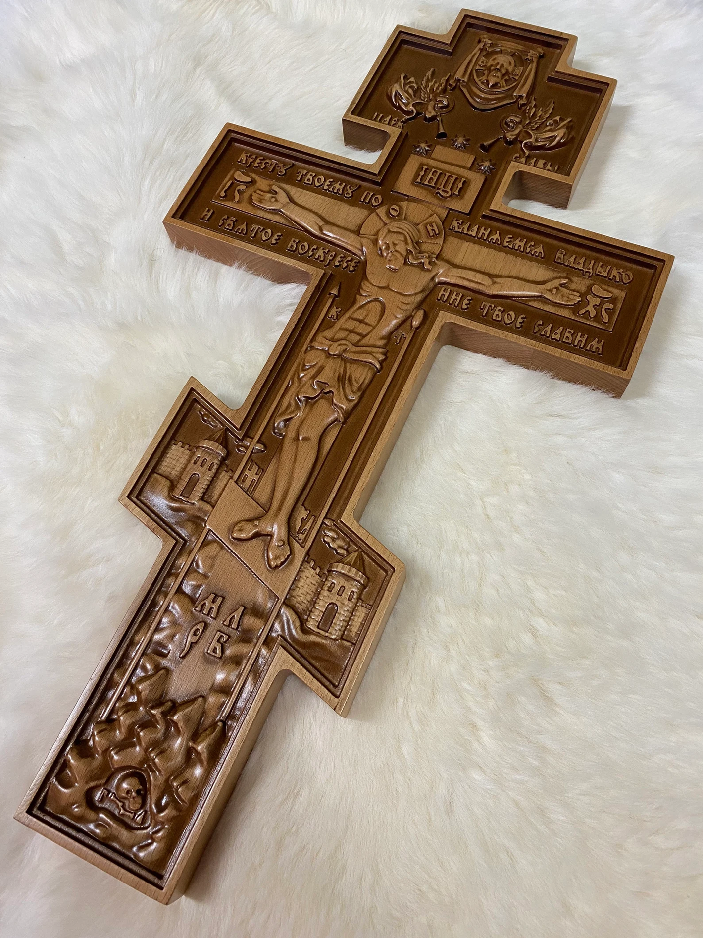 A Wall wooden orthodox cross, handmade in the Hutsul tradition with detailed religious iconography and Cyrillic inscriptions, is displayed on a soft white background.